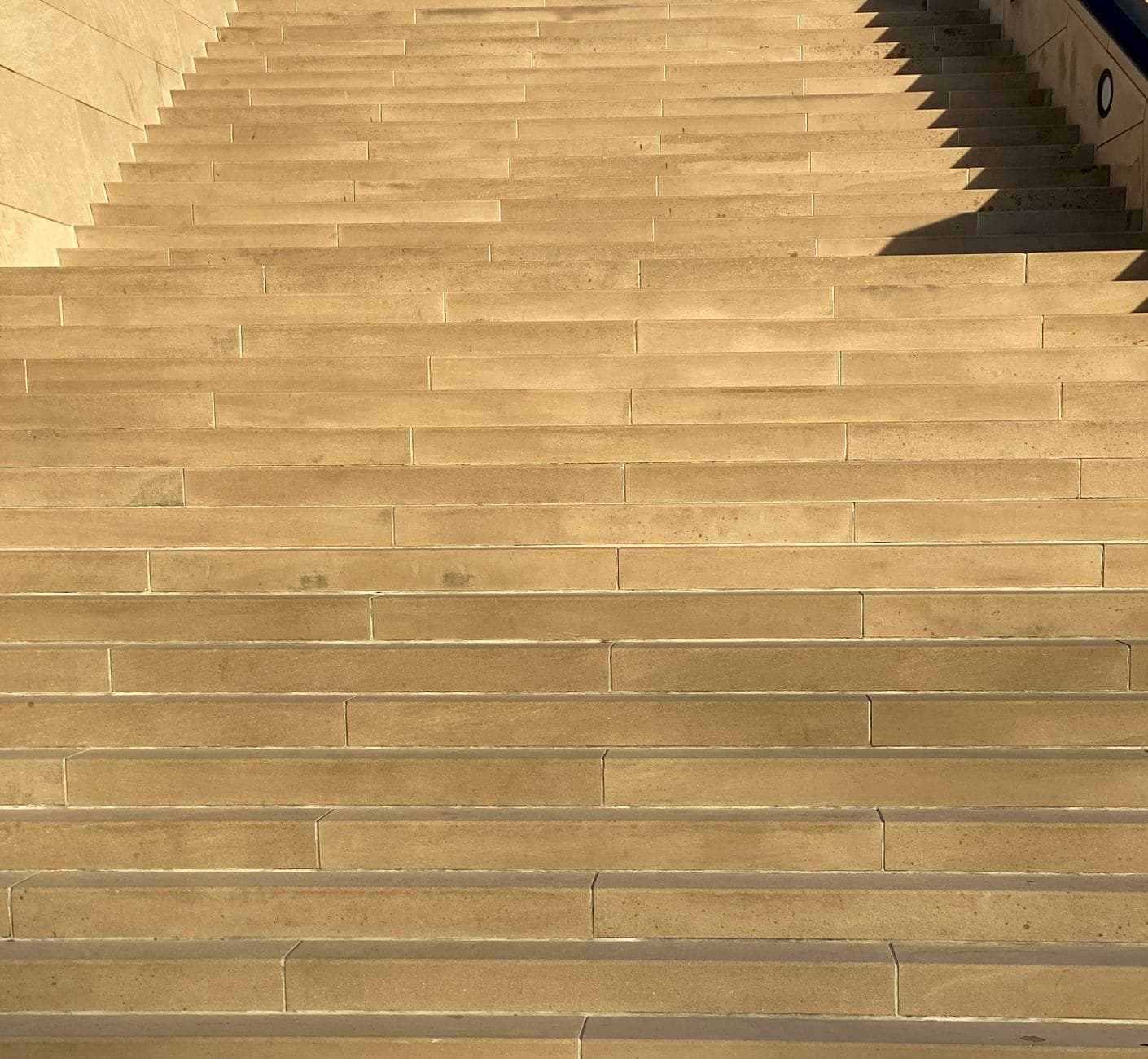 Stone staircase rising upward, representing breaking a big goal into manageable steps