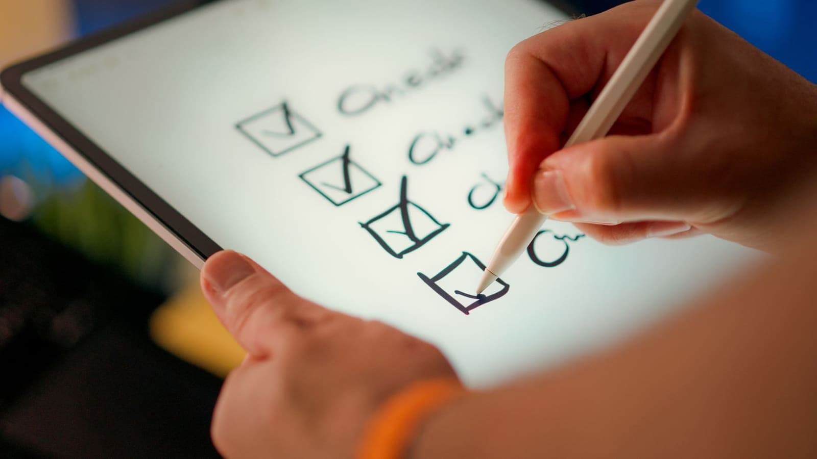 Open notebook with a handwritten checklist of tasks beside a pen