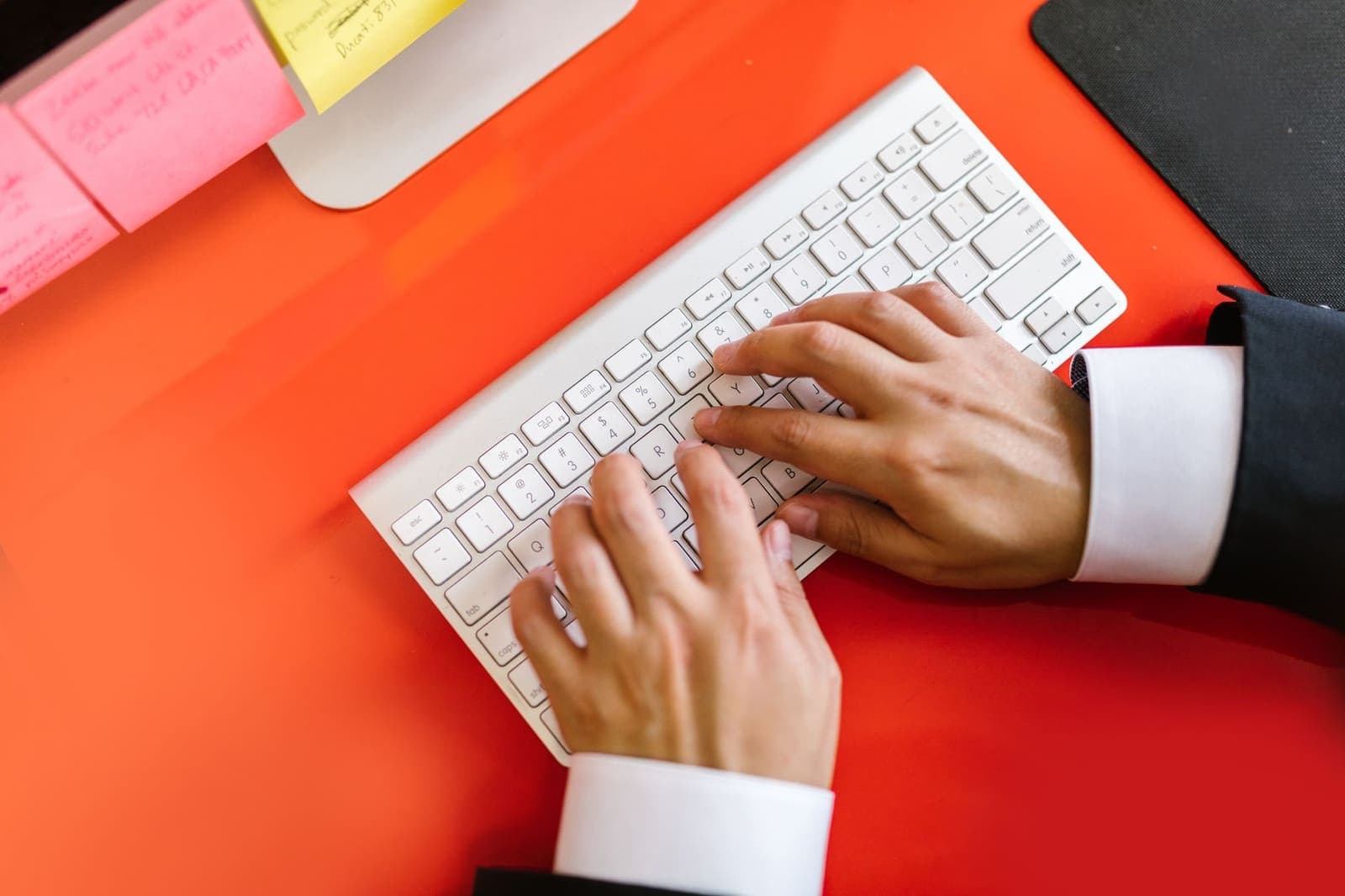Hands typing on a mechanical keyboard, close-up view