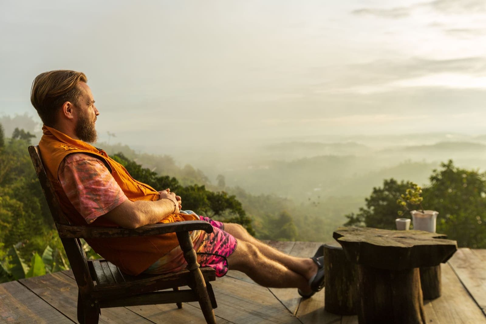 Person resting at a calm, minimal desk with a cup of tea, taking a quiet break from work