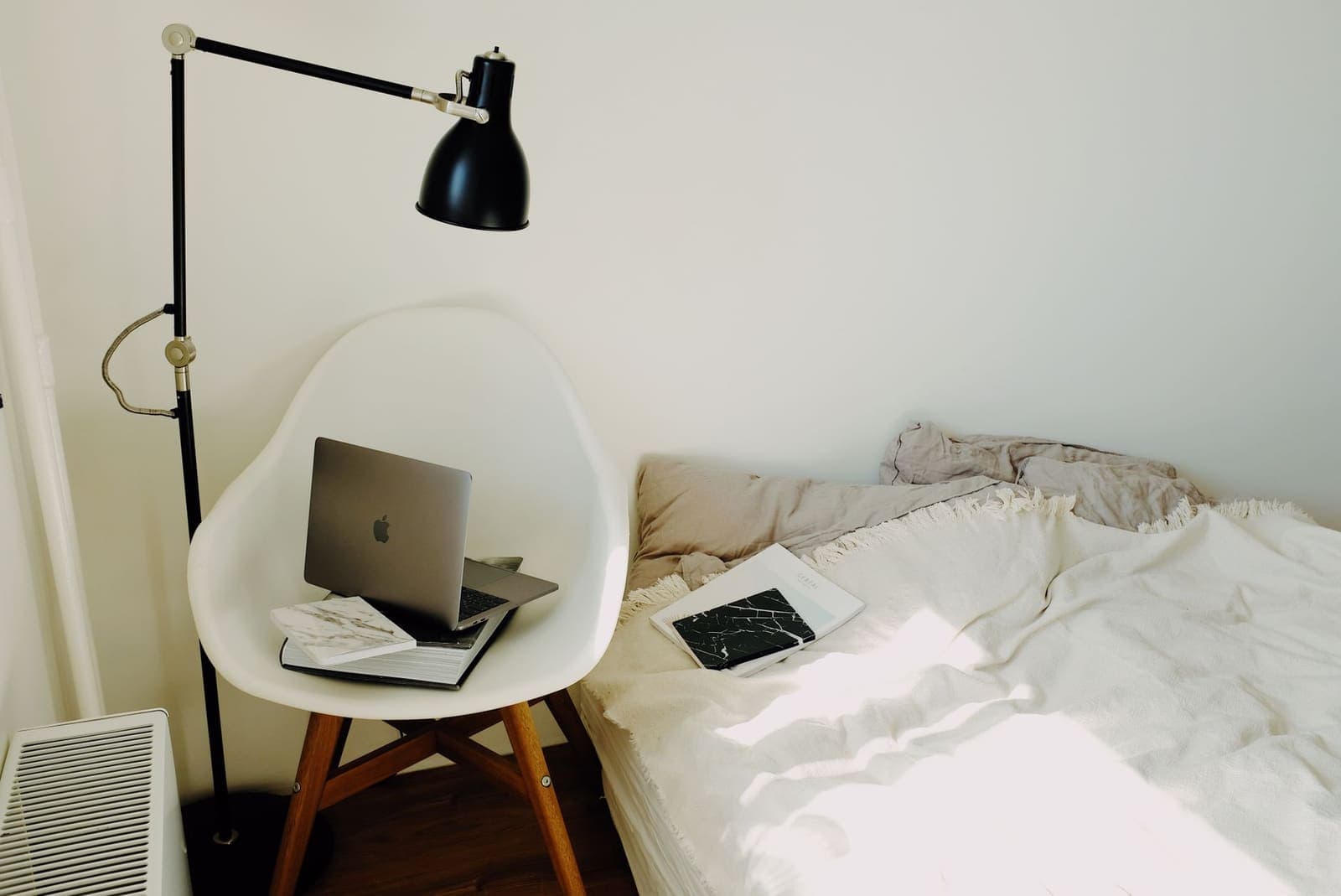 Calm, minimal desk workspace with a single notebook and coffee cup
