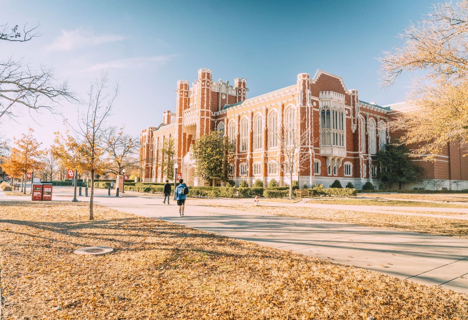 College campus with students walking past a building, representing semester planning and academic scheduling