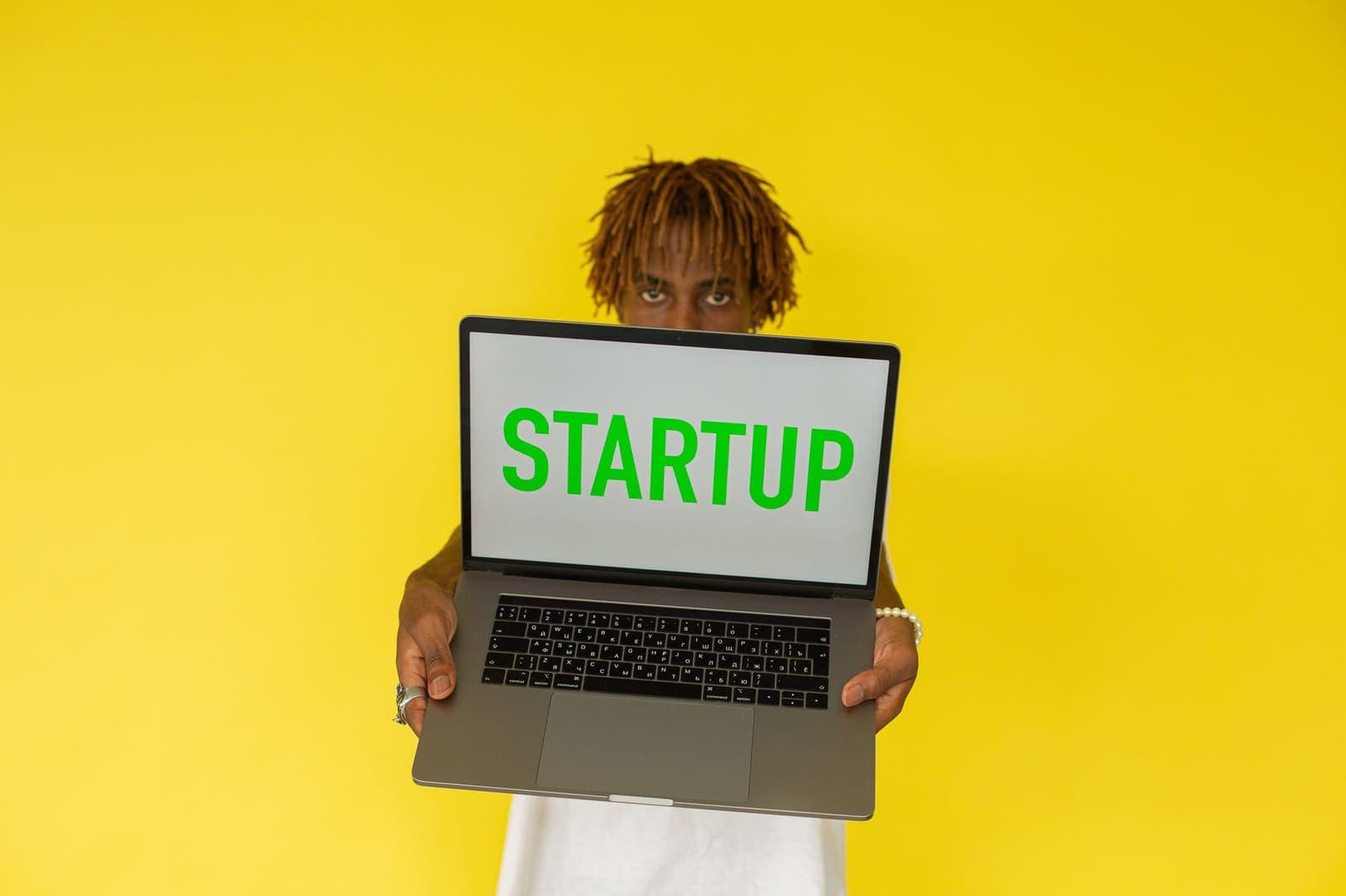 Solo founder working on a laptop at a minimal desk